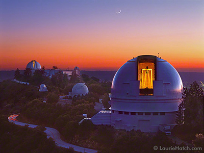 0032_LitSlits
© 2003 Laurie Hatch, image and text
- LICK OBSERVATORY
- Mt. Hamilton  California
2003 Spring

- Looking west from Kepler Peak at twilight, dome lights briefly illuminate  the Lick 36” (left) and Shane 120“ (right) telescopes. Soon the lights will be extinguished, and telescopes and domes will rotate toward the first objects of the night. Observing has already begun at the Nickel 40” Reflector in the smaller dome at horizon level just left of center; its darkened slit is also facing east. Midway between the Main Building and the Shane are the Tauchmann 22” Reflector left, and Carnegie Double Astrograph right.      

- The photographer thanks UCO / Lick Observatory staff for their continual and enthusiastic support.
- A VIEW FROM LICK OBSERVATORY 

- Lick Observatory crowns the 4,200-foot Mt. Hamilton summit above Silicon Valley in central California. This research station serves astronomers from University of California campuses and their collaborators worldwide. Eccentric Bay Area tycoon and philanthropist James Lick (1796-1876) bequeathed funding for construction which spanned from 1880 to 1887, fulfilling his vision of the Observatory as a premier astronomical facility. In 1959, the Shane 3-meter reflecting telescope was completed on Mt. Hamilton. It continues to provide data for forefront research and engineering programs. In total, the mountain top is home to ten telescopes which are supported by resident staff and by headquarters at UC Santa Cruz. Acclaimed for academic excellence, technical expertise, and superior instrumentation, Lick Observatory probes the expanding frontiers of space. 

- EXPOSURE DATA:

Pentax 67ii, 90mm f/2.8 lens
Velvia 50 Color Reversal film, shot at 100 ISO
Exposure: 4 seconds @ f/8 
 
- For more information: 
http://www.ucolick.org,
http://www.ucolick.org/public/telescopes/,

-lh@lauriehatch.com,
http://www.lauriehatch.com